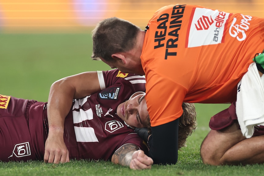 Reece Walsh is attended to by medical staff after being knocked out during State of Origin