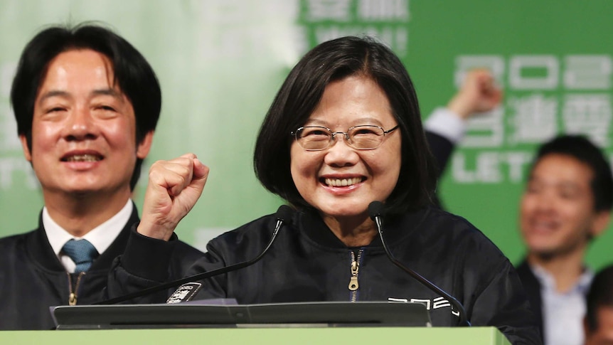 Taiwanese President Tsai Ing-wen clutches her fist as a sign of victory.