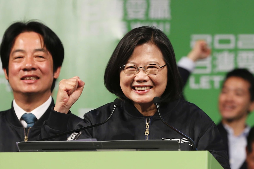 Taiwanese President Tsai Ing-wen clutches her fist as a sign of victory.