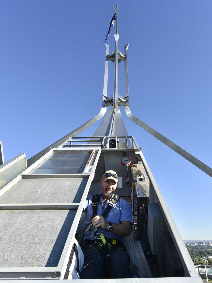 A man prepares to go up the flagpole