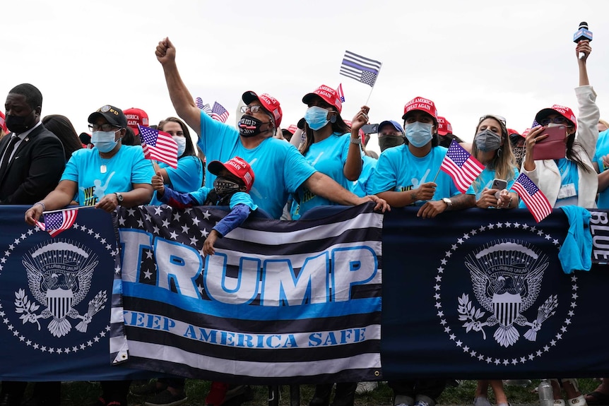 Supporters listen as President Donald Trump speaks.