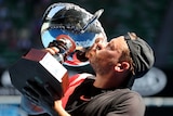 Dylan Alcott kisses the trophy after winning Quad Wheelchair Singles final at the Australian Open.
