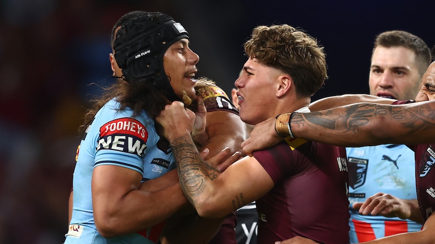 Jarome Luai of the Blues and Reece Walsh of the Maroons scuffle 
