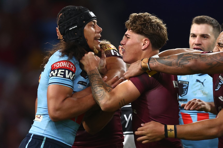Jarome Luai of the Blues and Reece Walsh of the Maroons scuffle 