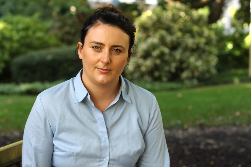 Headshot of a woman in a blue shirt