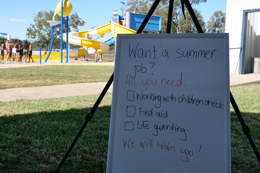 A sign saying: "Want a summer job? All you need, working with children check, first aid, lifeguarding. We will train you"