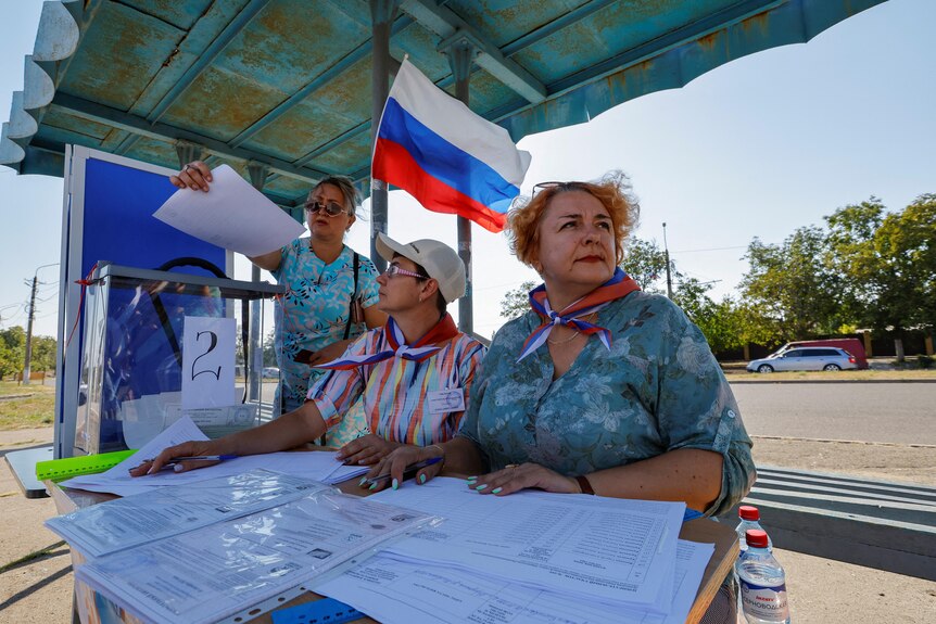A woman casts her ballot during an election in Russian occupied region in Ukraine.