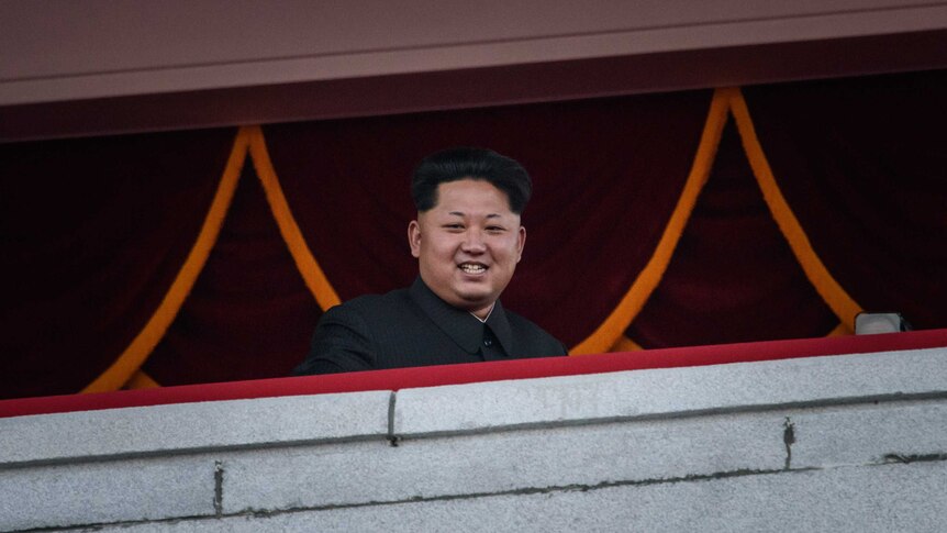 Kim Jong-Un looking over a mass military parade.