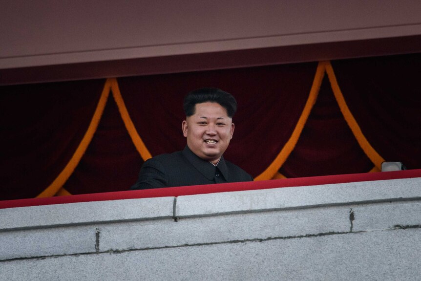 Kim Jong-Un looking over a mass military parade.