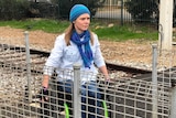 Adelaide rail user Jodie Pearce crosses the Tonsley line in a wheelchair.