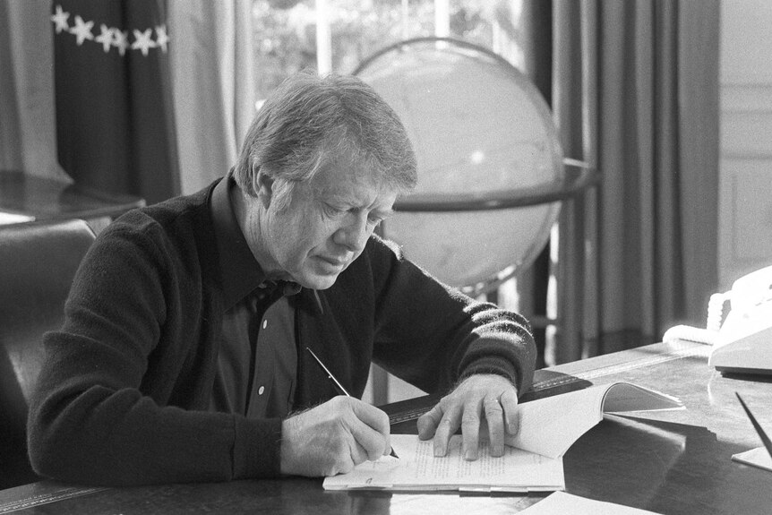 Jimmy Carter at his desk in the oval office, 1977