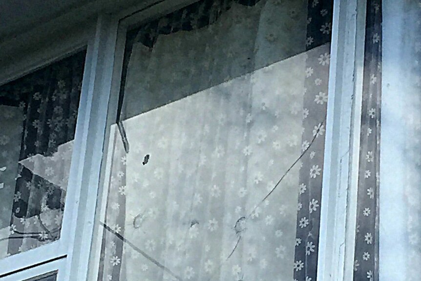 The window of a Hobart house riddled with bulletholes