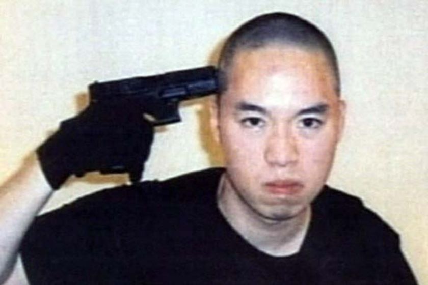 Cho Seung-Hui points a gun at the camera.