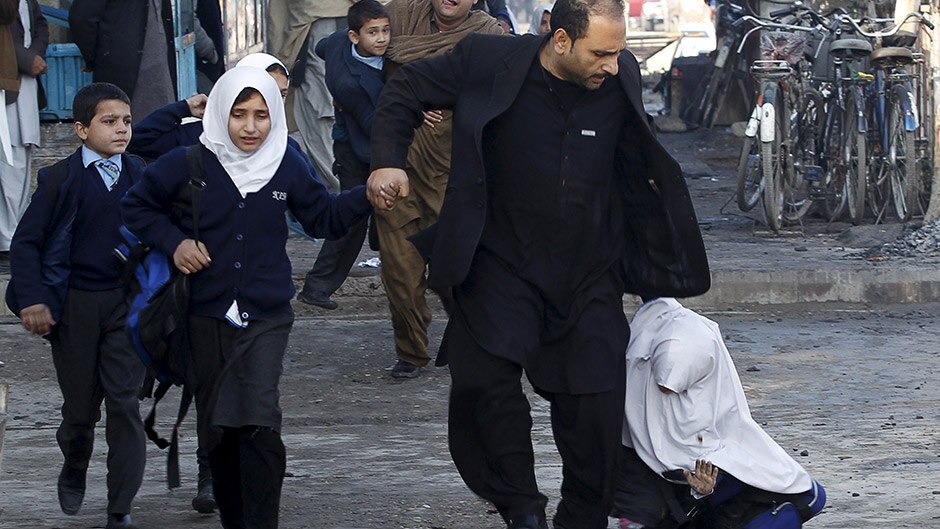 A school girl falls as she and others run after a blast near the Pakistani consulate in Jalalabad, Afghanistan.