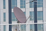 A broadband satellite mounted on a building.