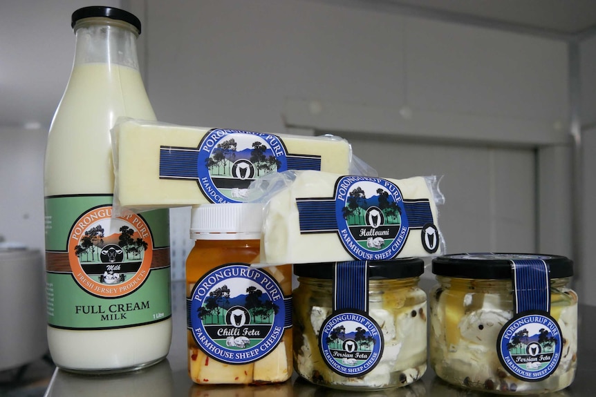 A collection of cheese products and milk in a jar.