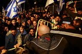 People attend a demonstration after Israeli Prime Minister Benjamin Netanyahu dismissed the defense minister.