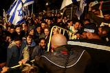People attend a demonstration after Israeli Prime Minister Benjamin Netanyahu dismissed the defense minister.