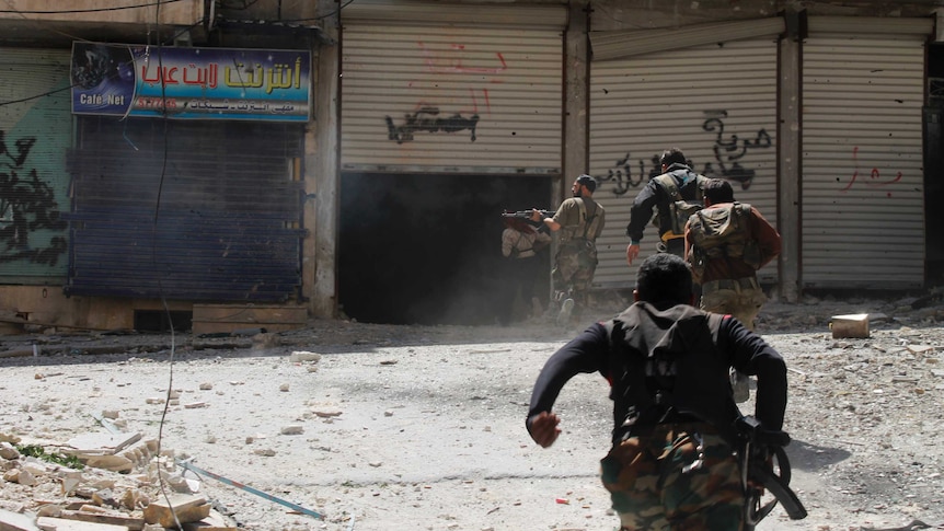 Free Syrian Army soldiers run for cover