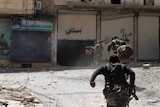 Free Syrian Army soldiers run for cover