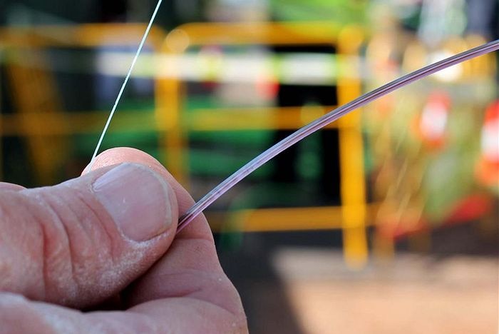 A person holding a piece of NBN fibre.