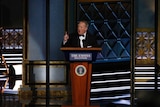 Former White House Press Secretary Sean Spicer at a podium.