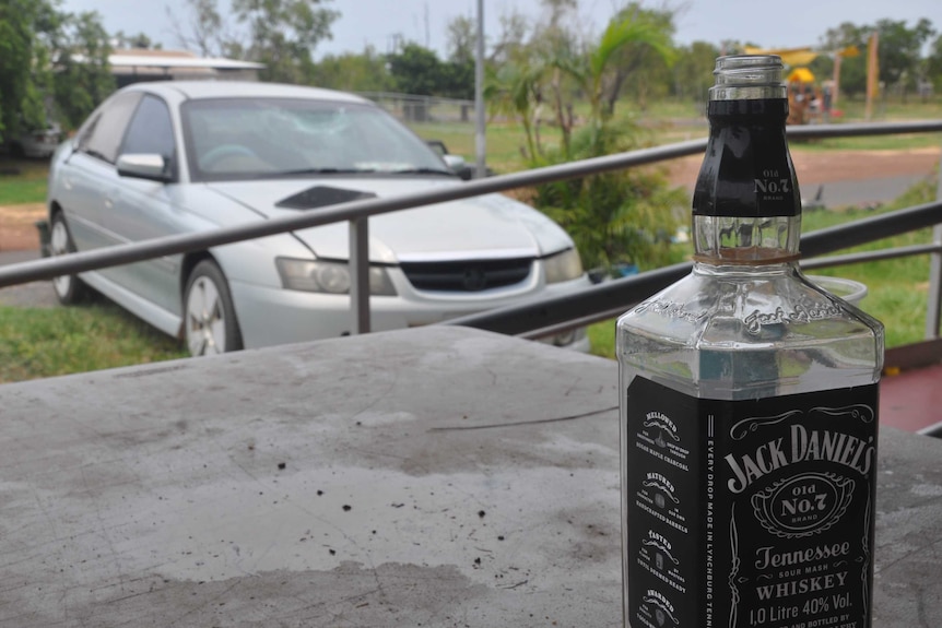 A bottle of Jack Daniel's stands empty on a table at Darwin's Minmirama community.
