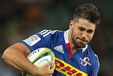 Jacobus Van Wyk of the Stormers is tackled by Rob Horne