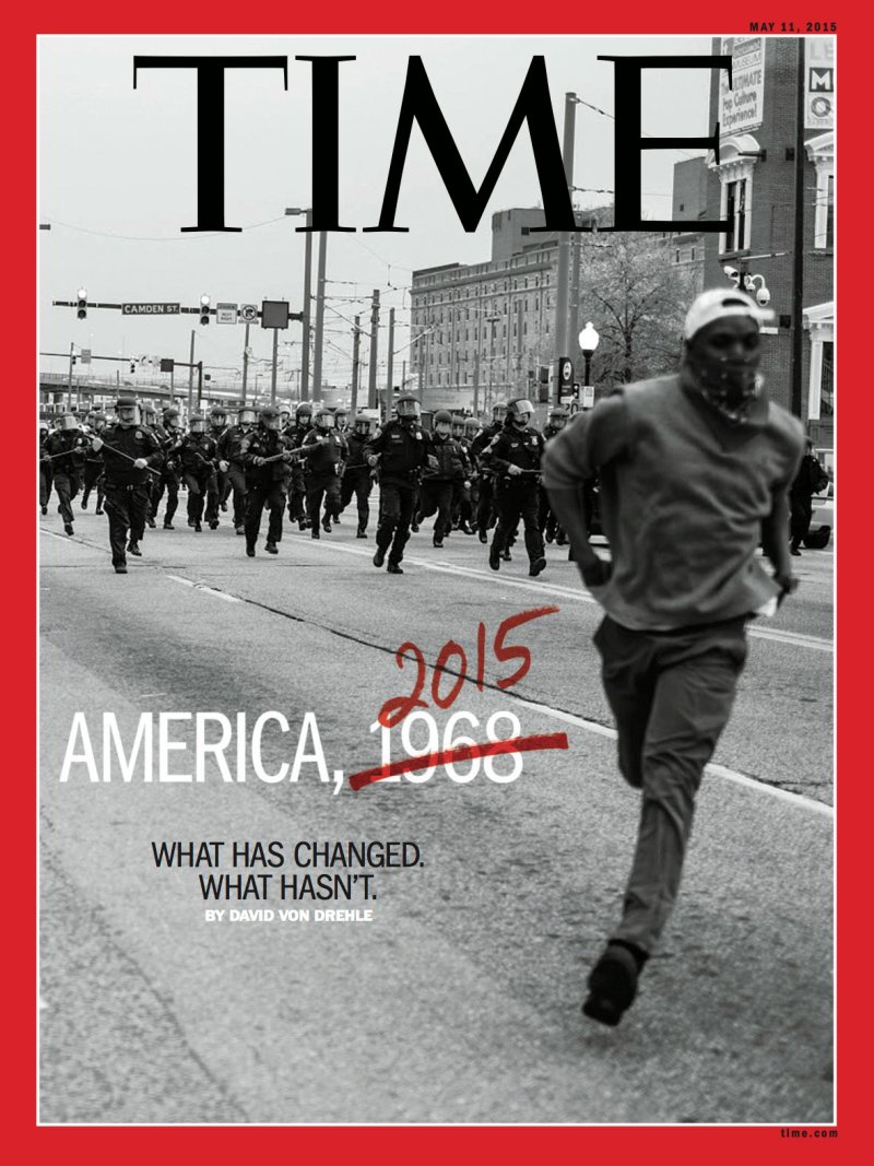 A Time magazine cover shows a black man running away from a crowd of police in riot gear