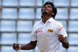Sri Lanka's Lakshan Sandakan clenches his fists to celebrate taking a wicket.