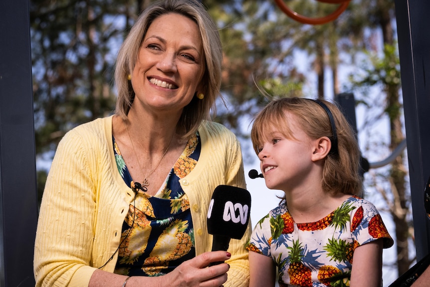 A woman interviewing a girl