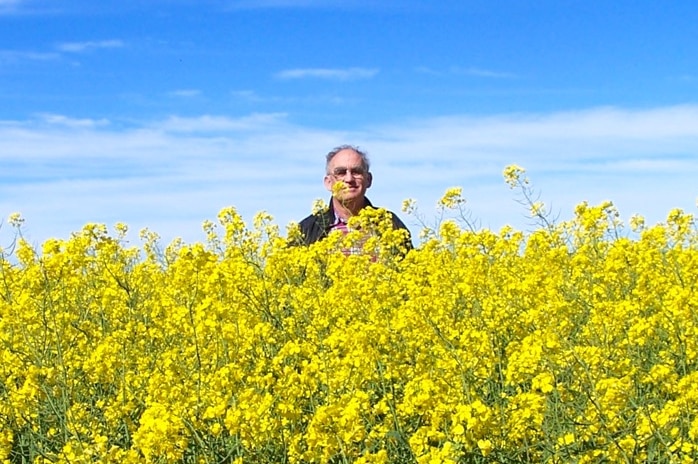 Mr Cronin stands in the field