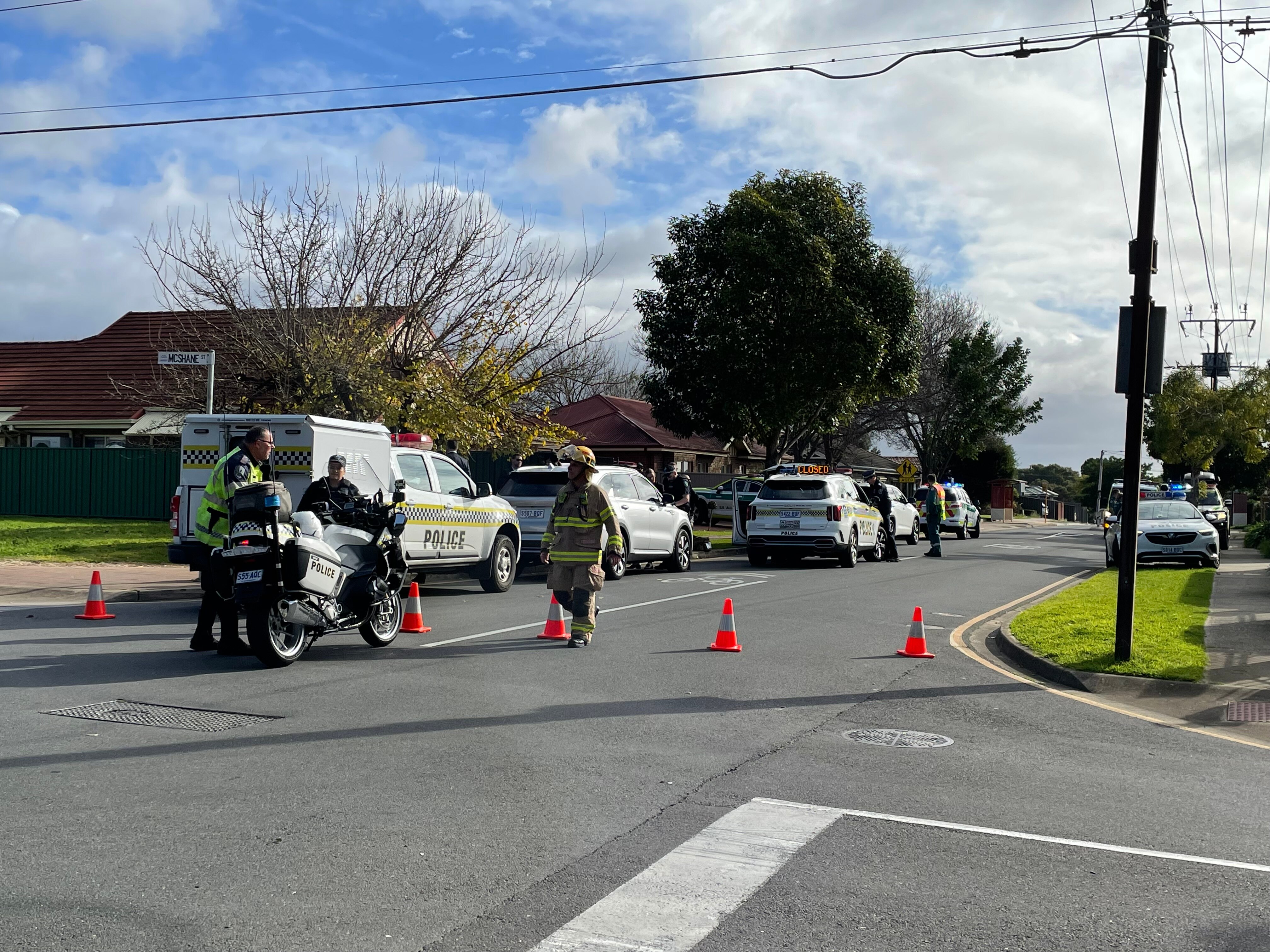 Police cars parked on a suburban street.