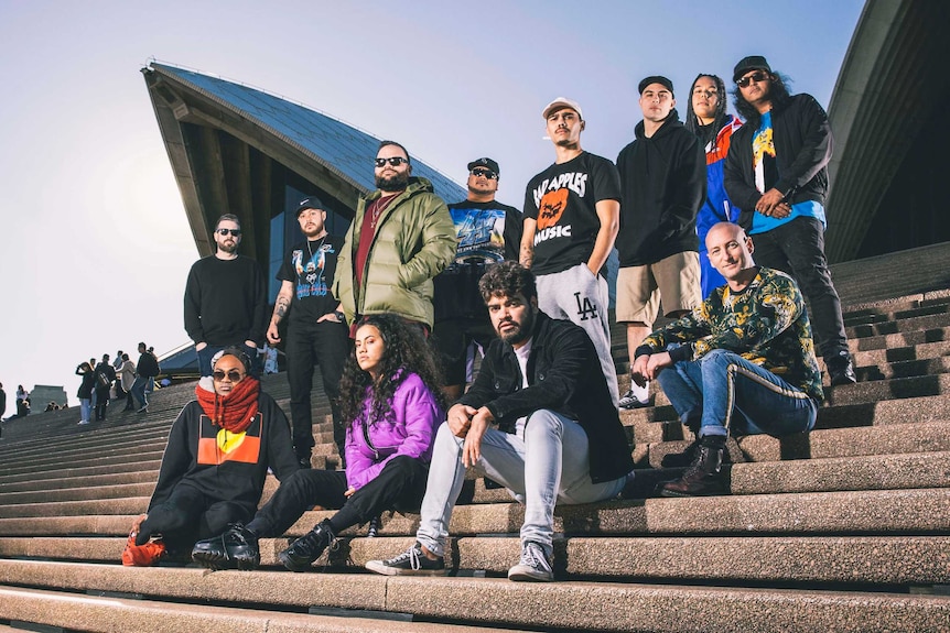 Colour photo of the Briggs' Bad Apples House Party line-up posing on the steps of the Sydney Opera House.