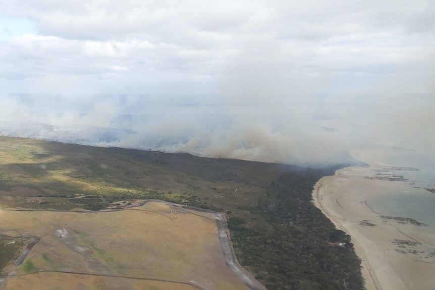 Aerial view of a bushfire on coastal area.