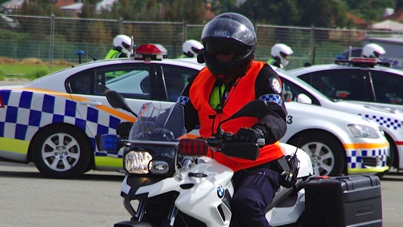 A police officer sits on an unmarked motorbike which will be used to crack down on driving offences on the weekend.