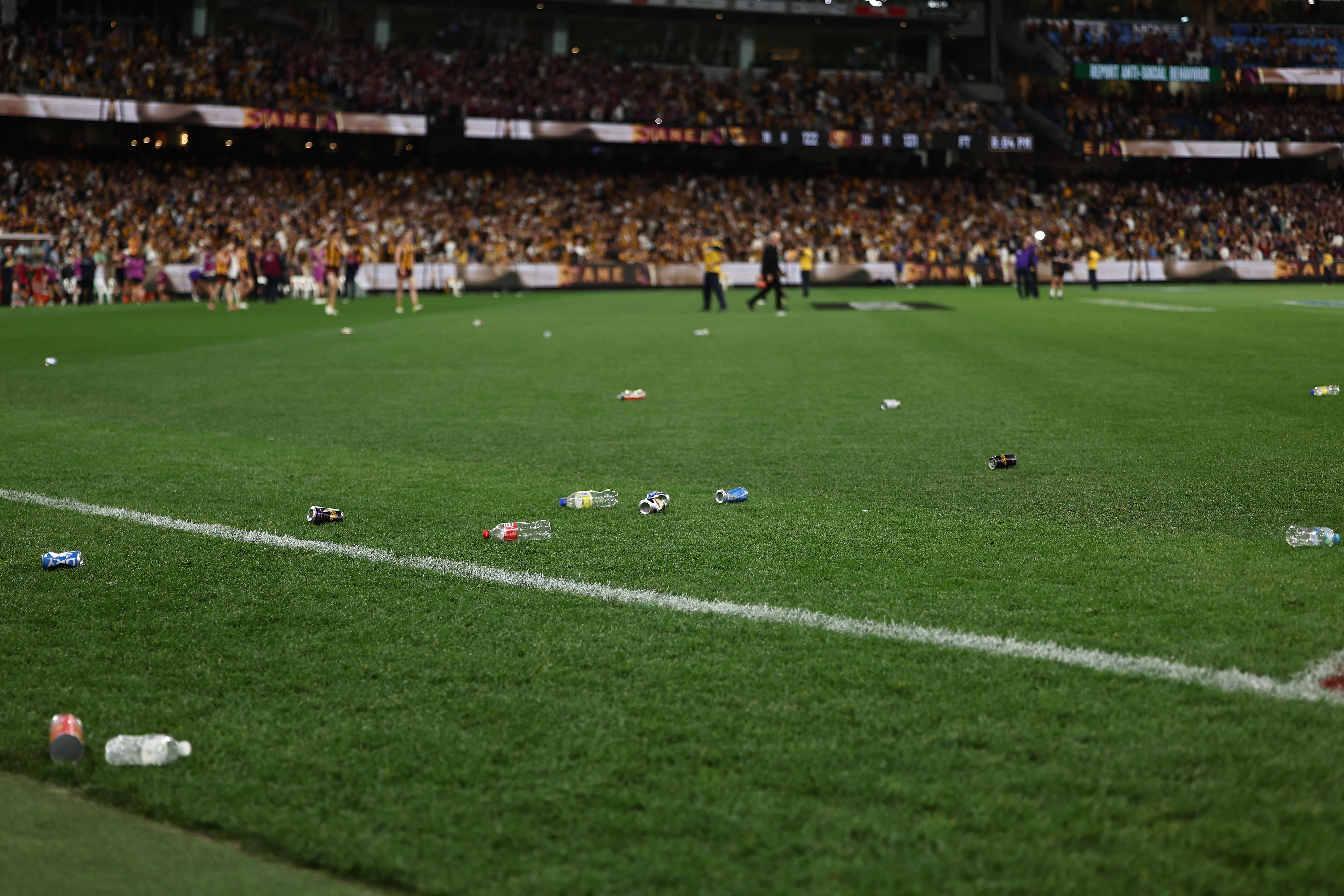 Bottles on the field after the 2026 AFL preliminary final at the MCG.