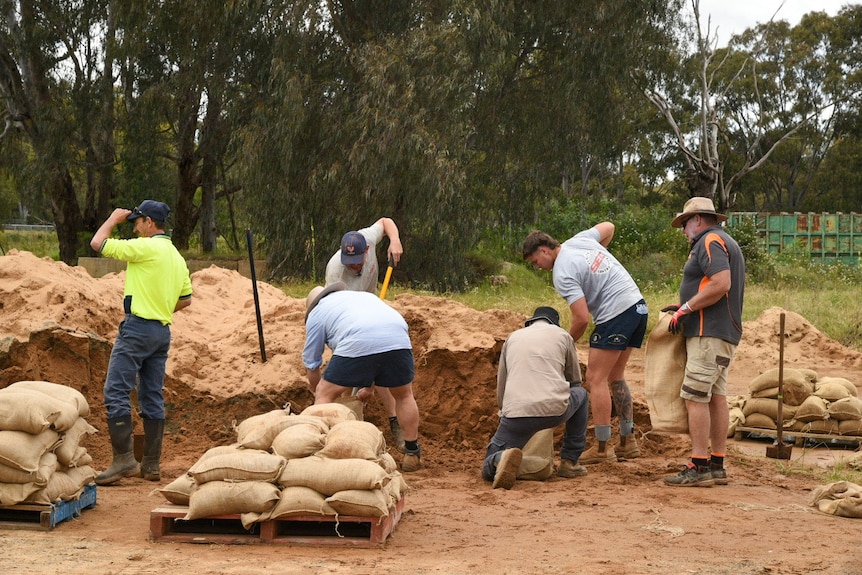 People sandbagging with shovels 