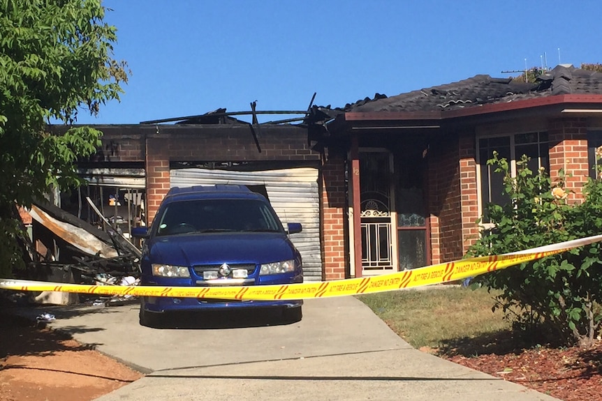 The burned out house, with a collapsed roof.