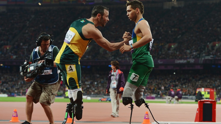 Alan Oliveira of Brazil is congratulated by Oscar Pistorius of South Africa after Oliveira won gold in the men's 200m - T44 final at the London Paralympics on September 2, 2012 in London, England.