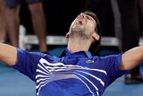 Novak Djokovic celebrates on his knees, pumping his arms high above him after winning the Australian Open