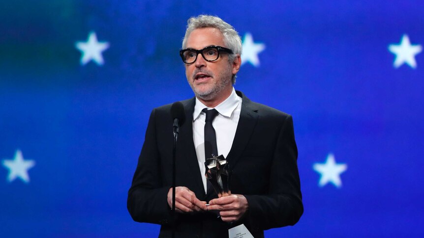 Alfonso Cuaron accepts an award for Best Director for ROMA.