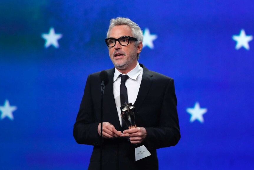 Alfonso Cuaron accepts an award for Best Director for ROMA.