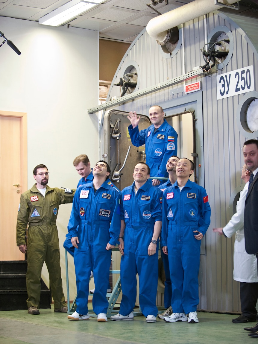 Mars500 experiment crew members react after leaving the mock spaceship in Moscow November 4, 2011.