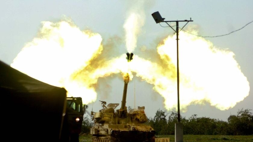 An Israeli artillery gun fires at the Gaza Strip