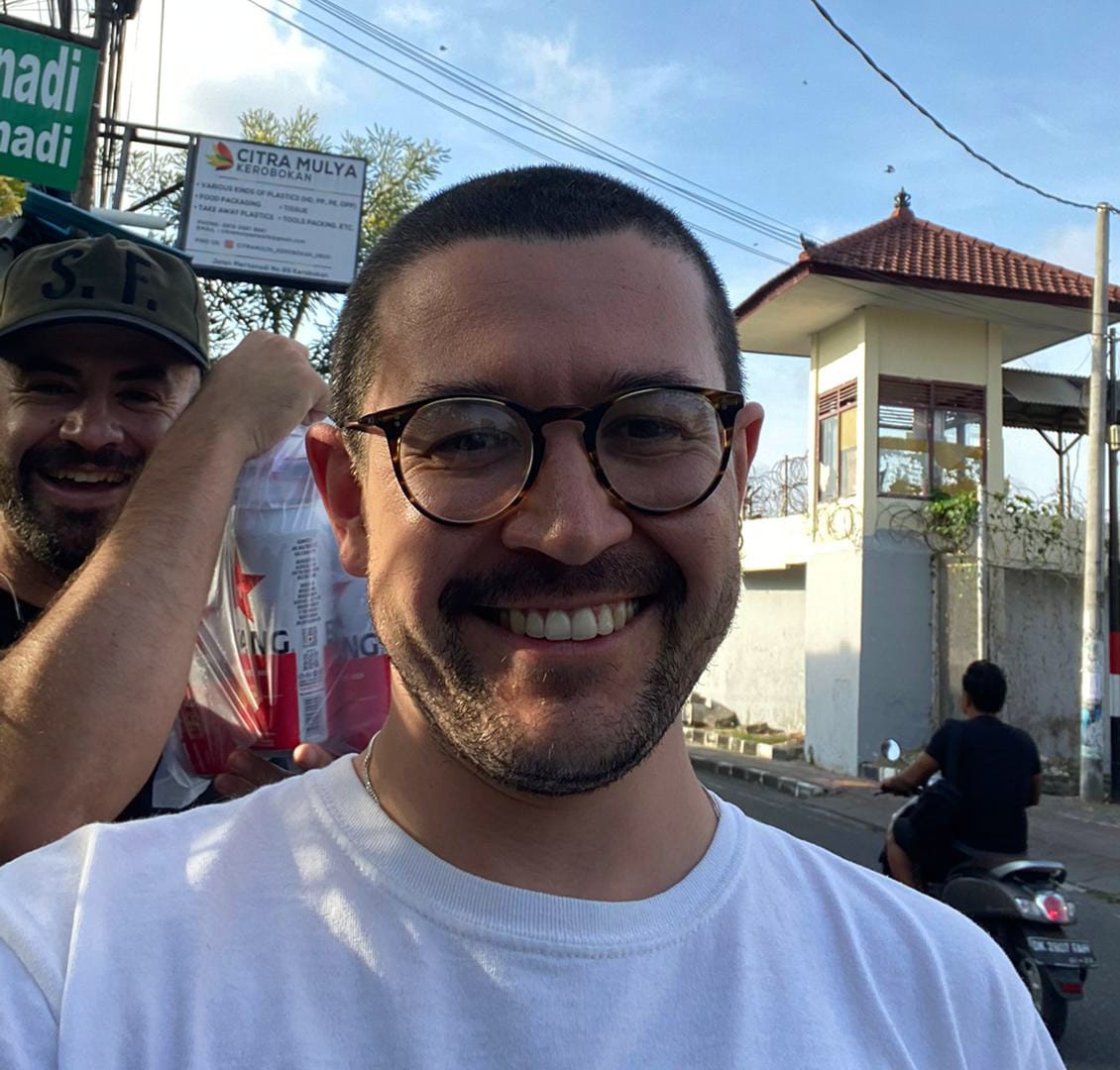 a man smiling close up wearing a glasses