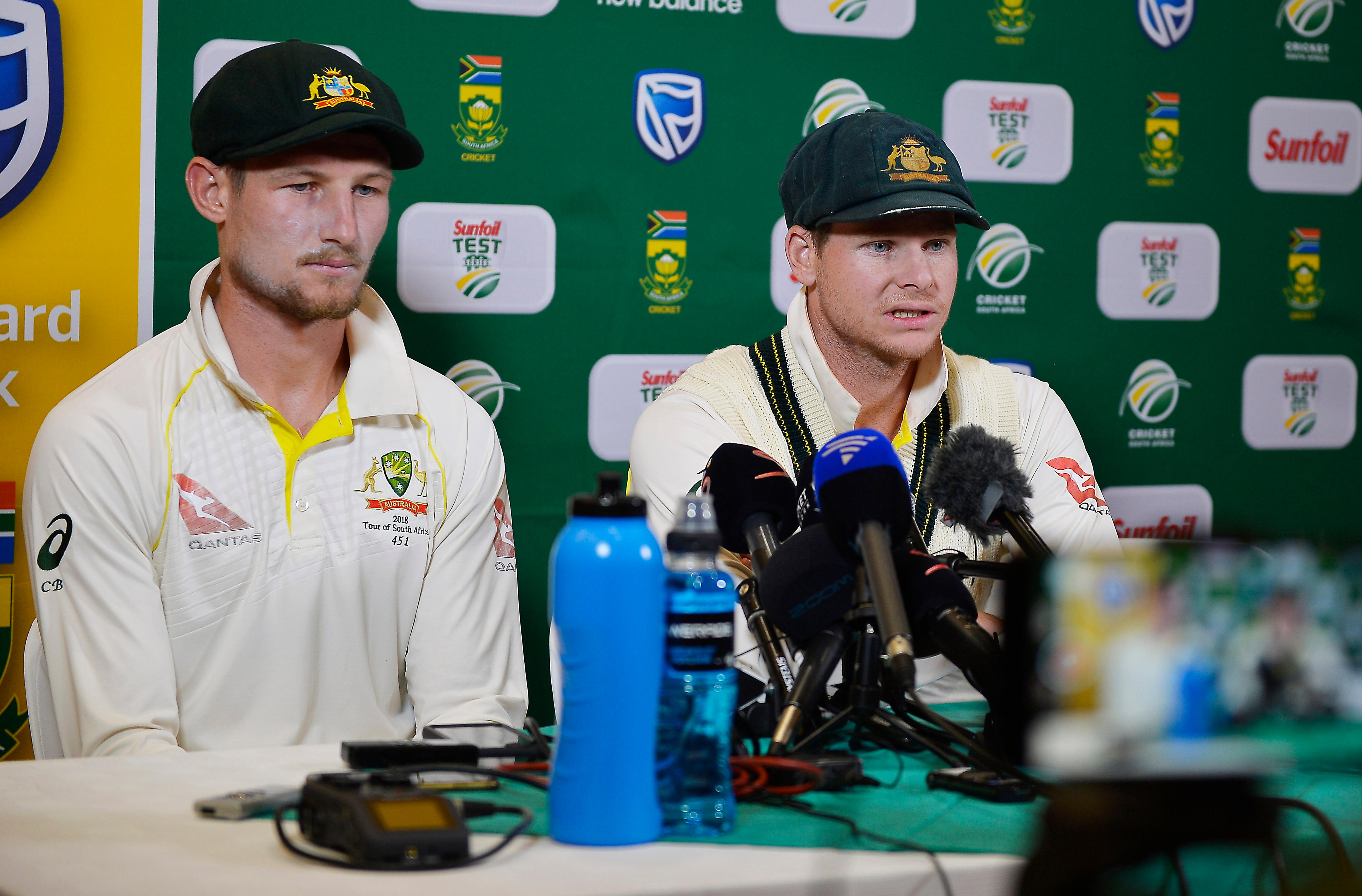 Cameron Bancroft and Steve Smith sit at a press conference