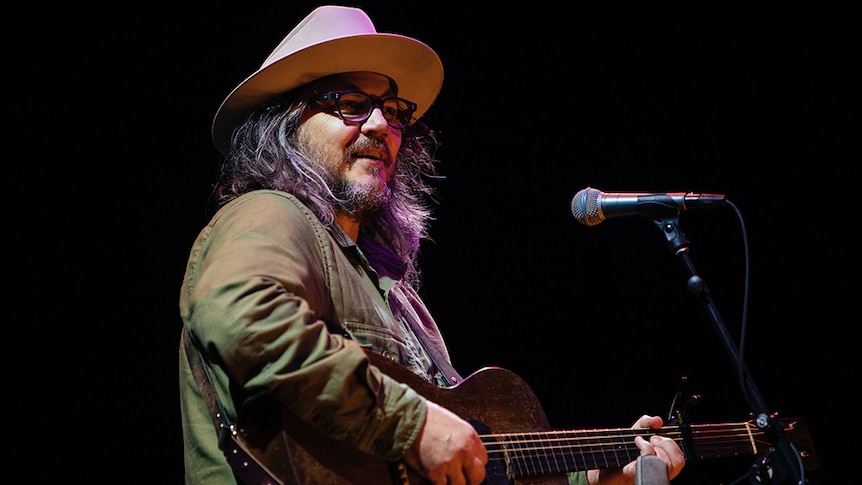 Jeff Tweedy from Wilco playing guitar at a live show
