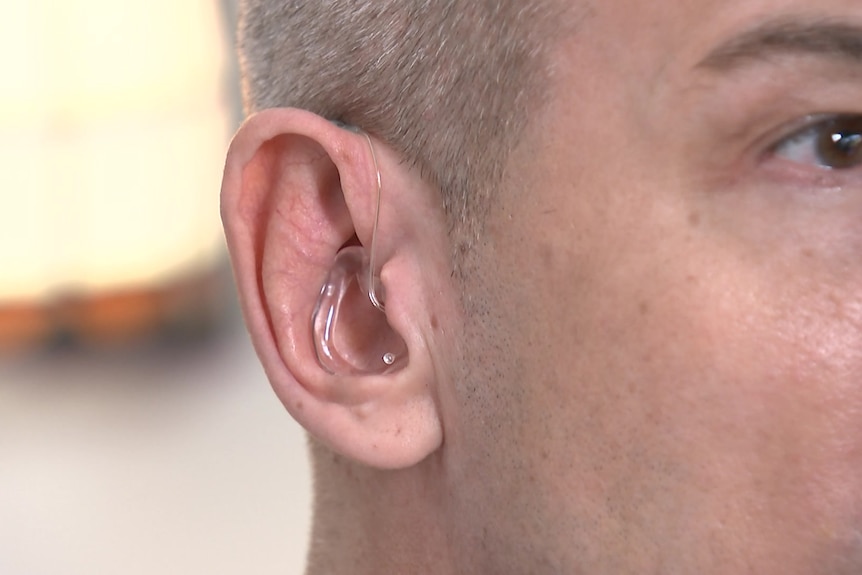 the profile of a man who is wearing hearing aids 