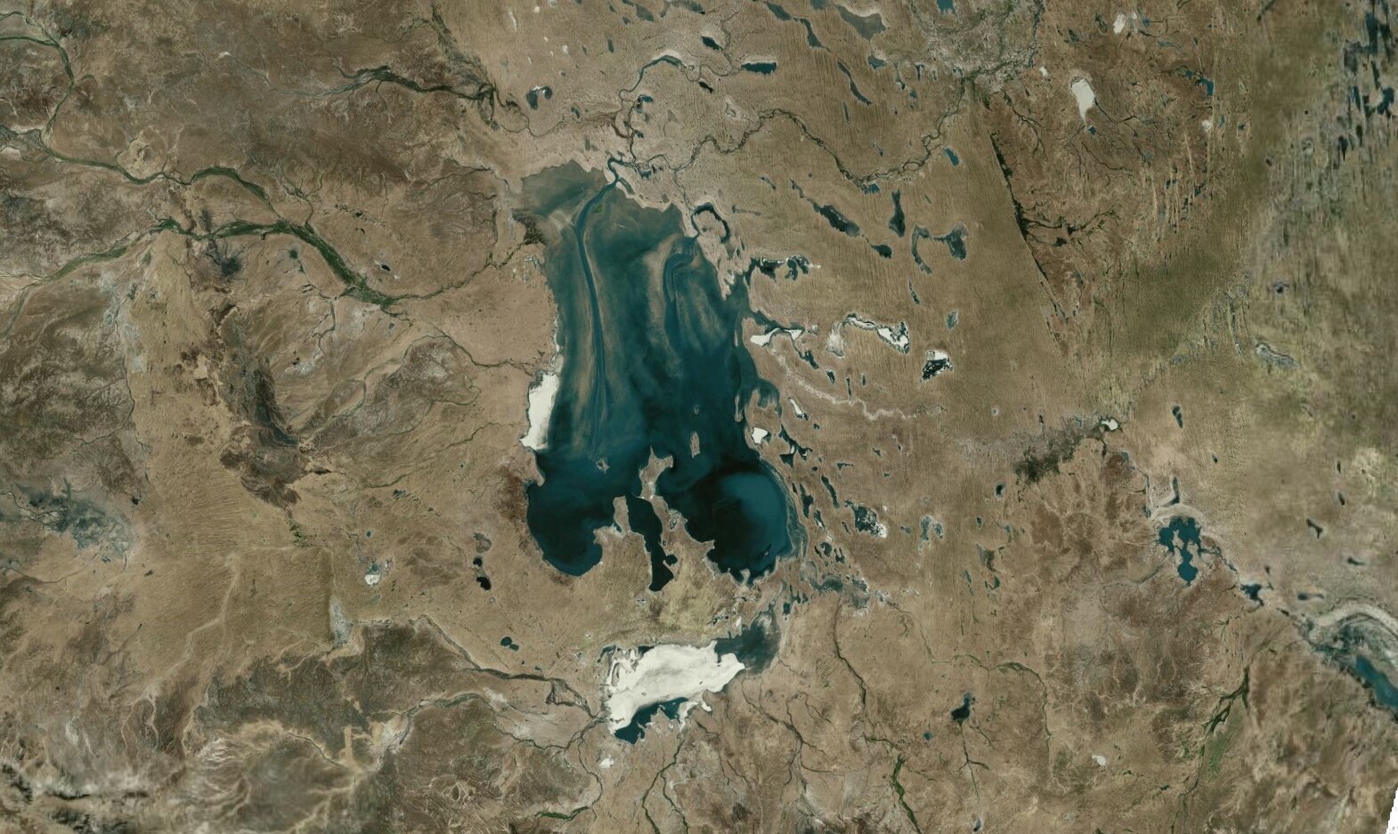 A satellite image shows Kati Thanda-Lake Eyre full with a blue body of water in the middle of desert country.